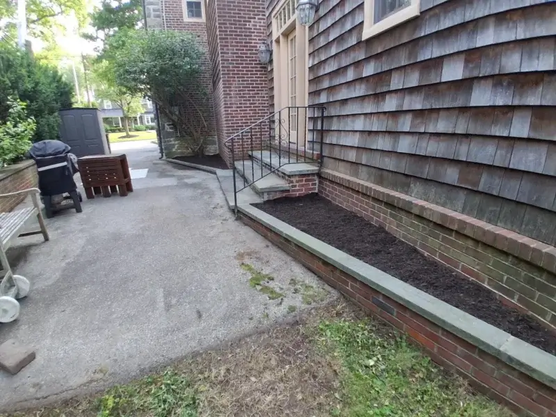 Landscaped side yard with brick garden beds.